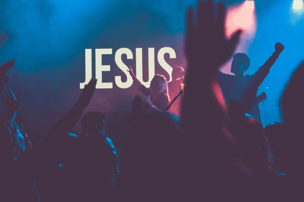 A crowd of worshippers with hands raised