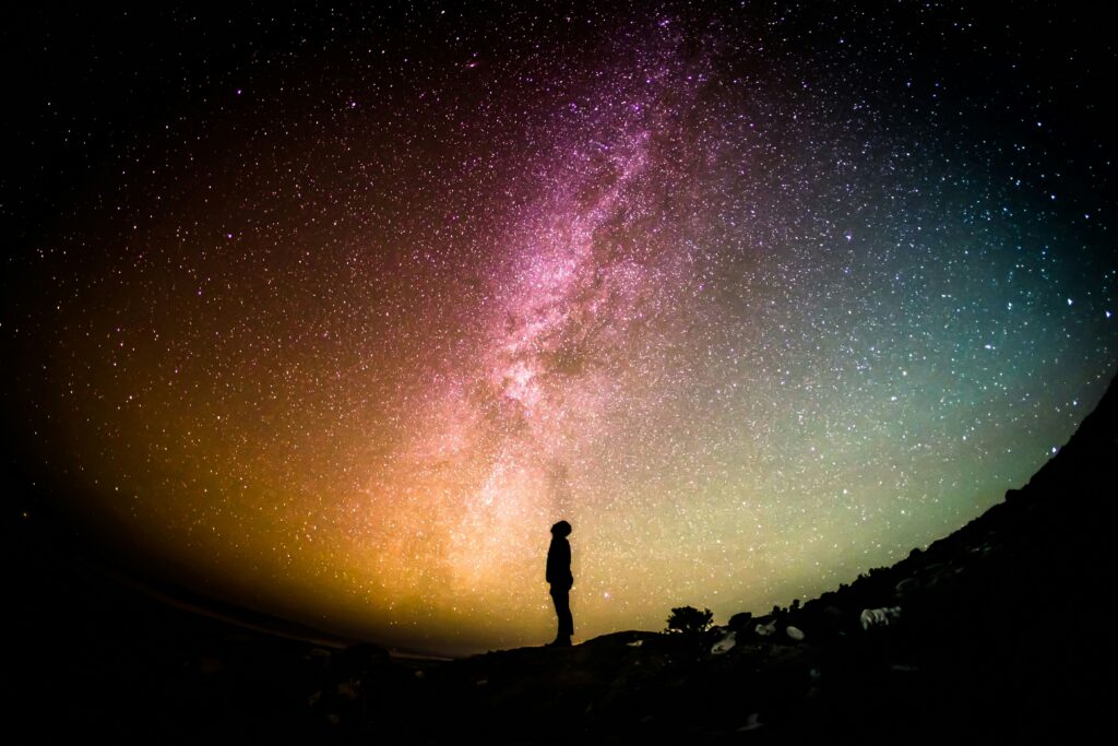 A person standing beneath a starry night sky